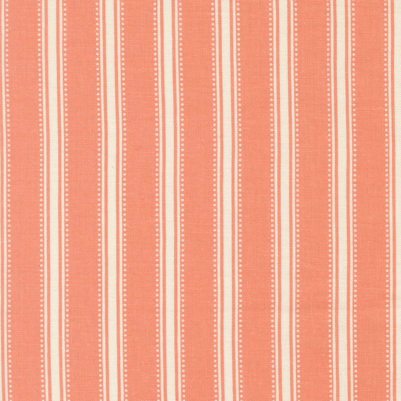 Coral pink fabric with dotted cream stripes.