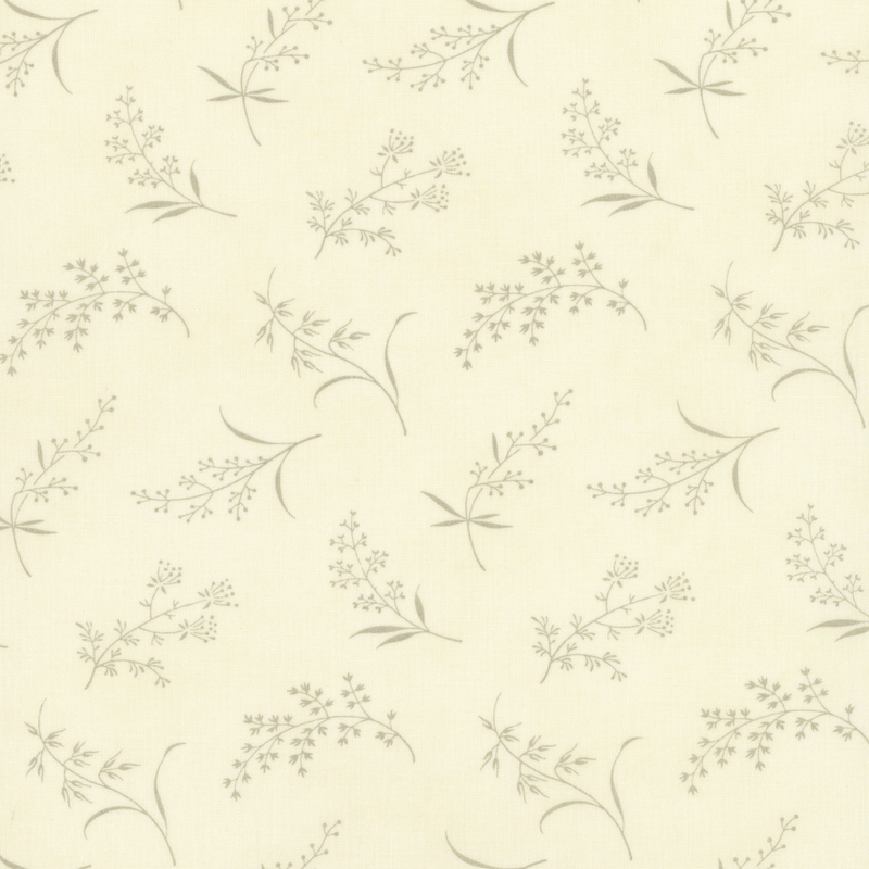 Fabric pattern of ditsy leaves and flowers on a cream background.