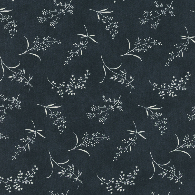 Fabric pattern of ditsy leaves and flowers on a dark blue background.