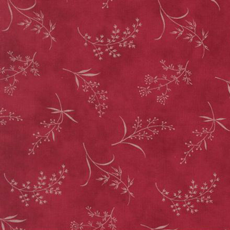 fabric pattern of ditsy leaves and flowers on a red background