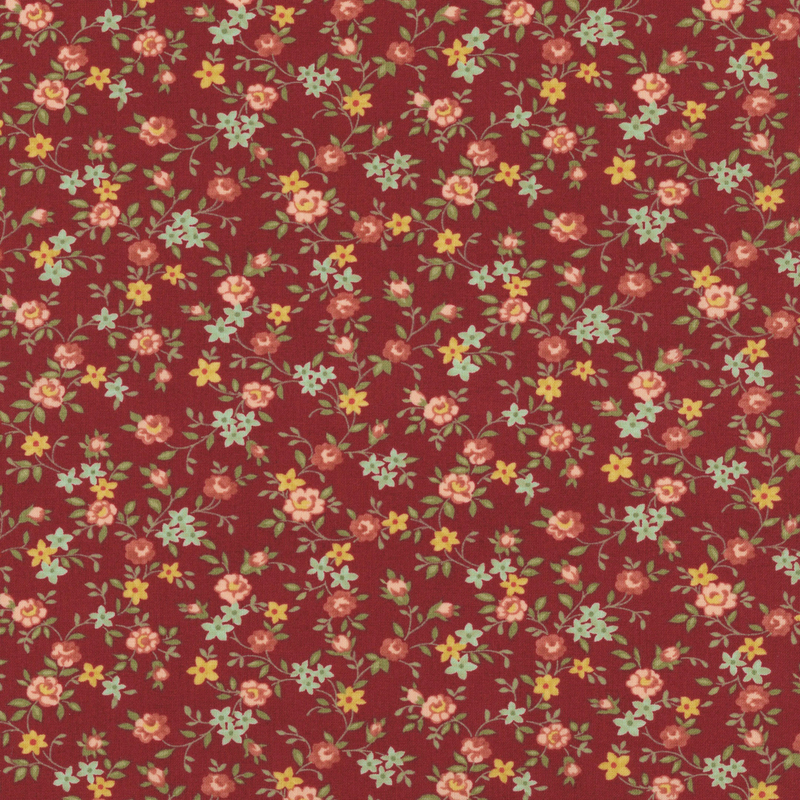 Fabric pattern of scattered roses all over a red background.