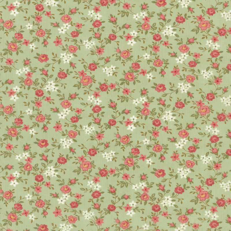 Fabric pattern of scattered roses all over a green background.