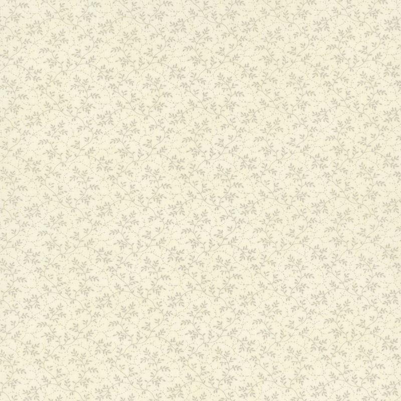 fabric pattern of thin, leafy vines scattered all over a cream background.