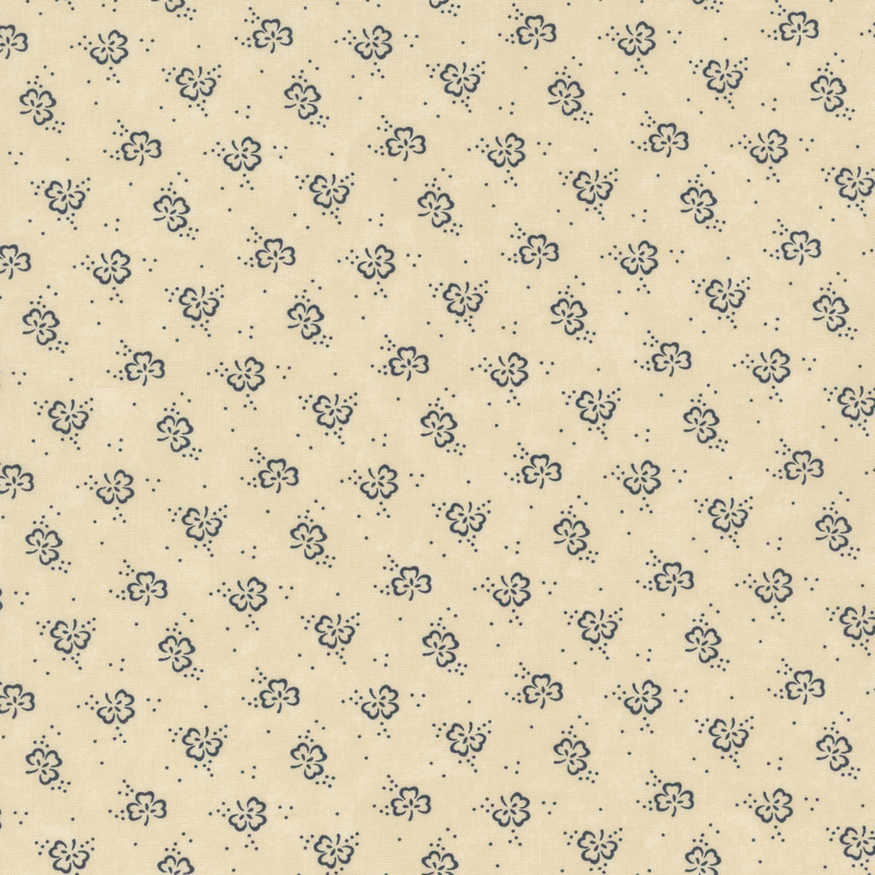 A beige fabric with a repeating pattern of small, dark blue floral motifs.