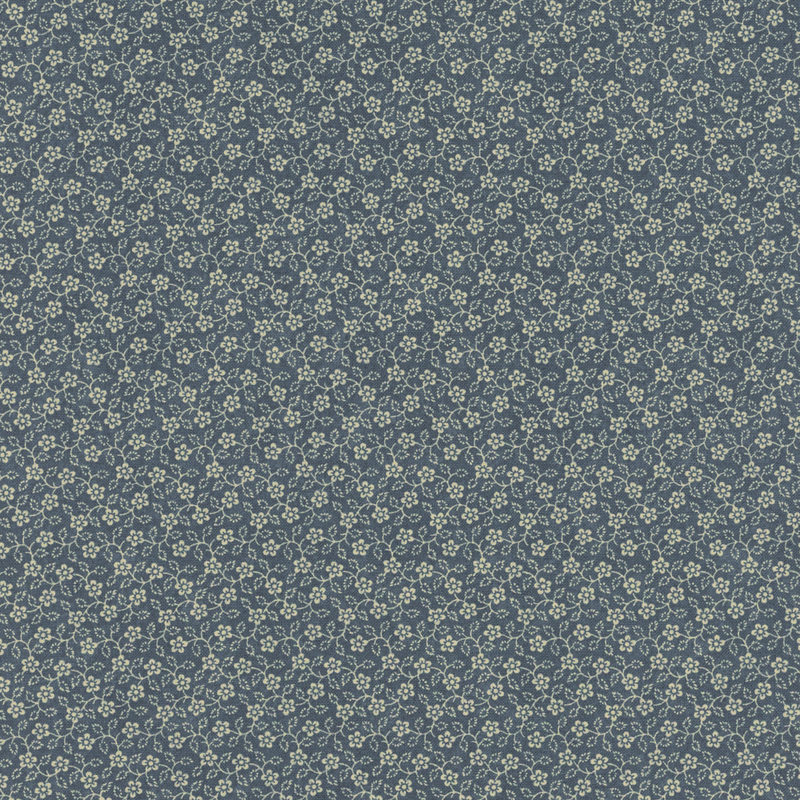 Navy blue fabric with a repeating pattern of small, delicate white flowers and green leaves.