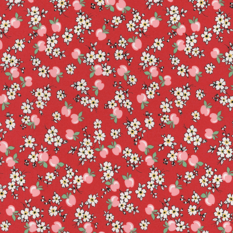 fabric pattern of apples and flowers on a red background