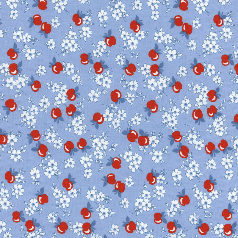 fabric pattern of apples and flowers on a blue background