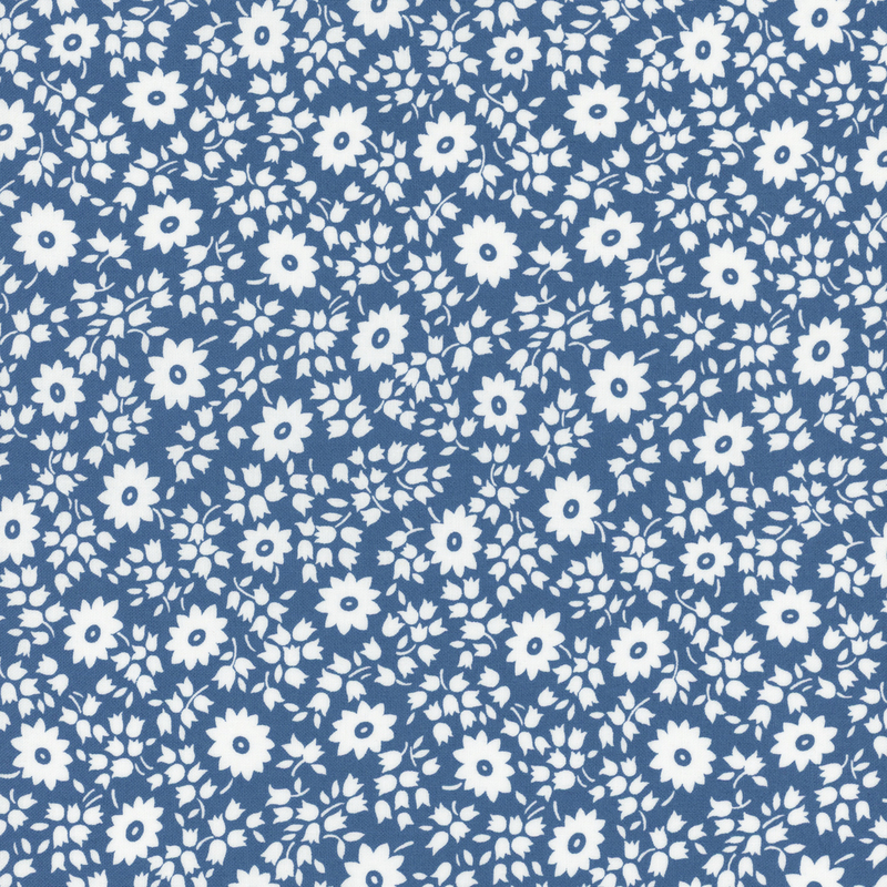 fabric pattern of white florals on a blue background