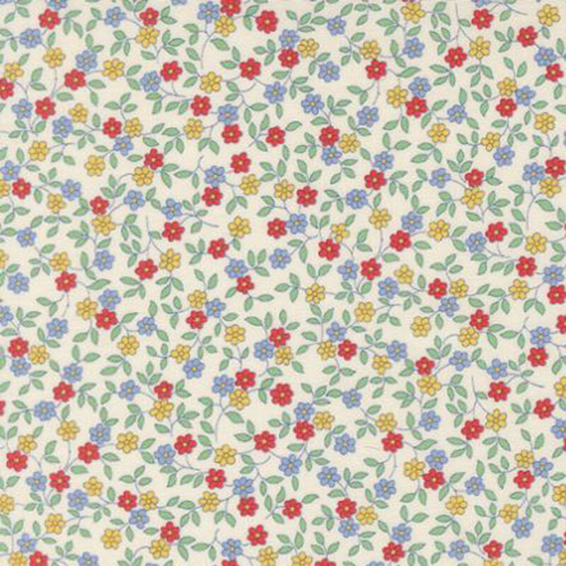 fabric pattern of  red, yellow, and blue florals scattered all over a white background