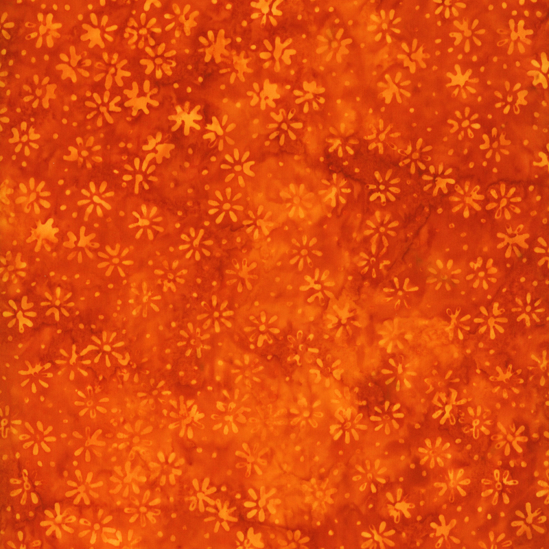 fabric pattern of flower motifs on a orange background