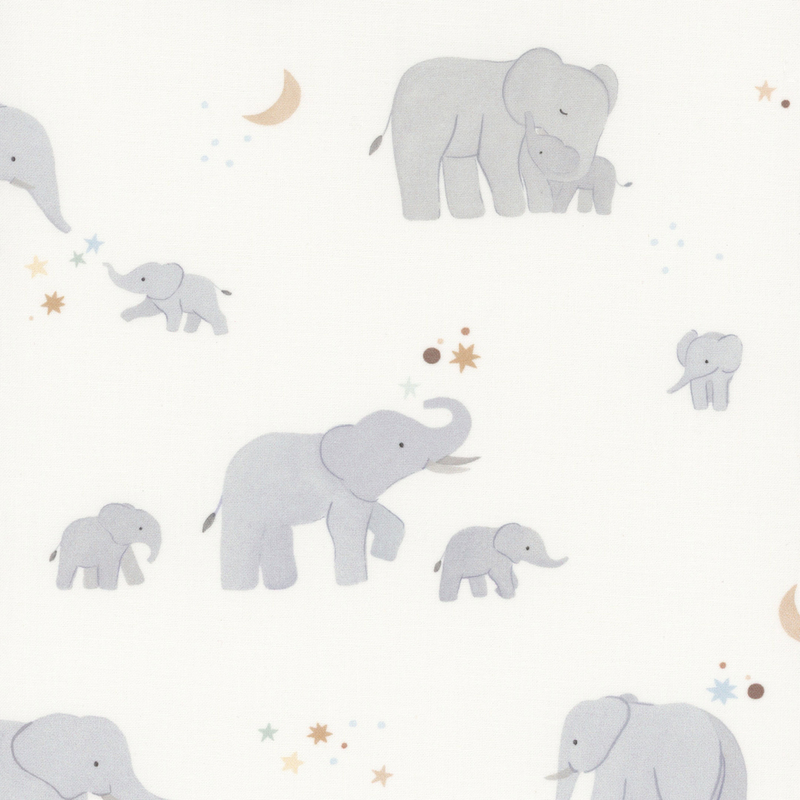 Cream fabric with scenes of mama elephants with their babies on a starry background.