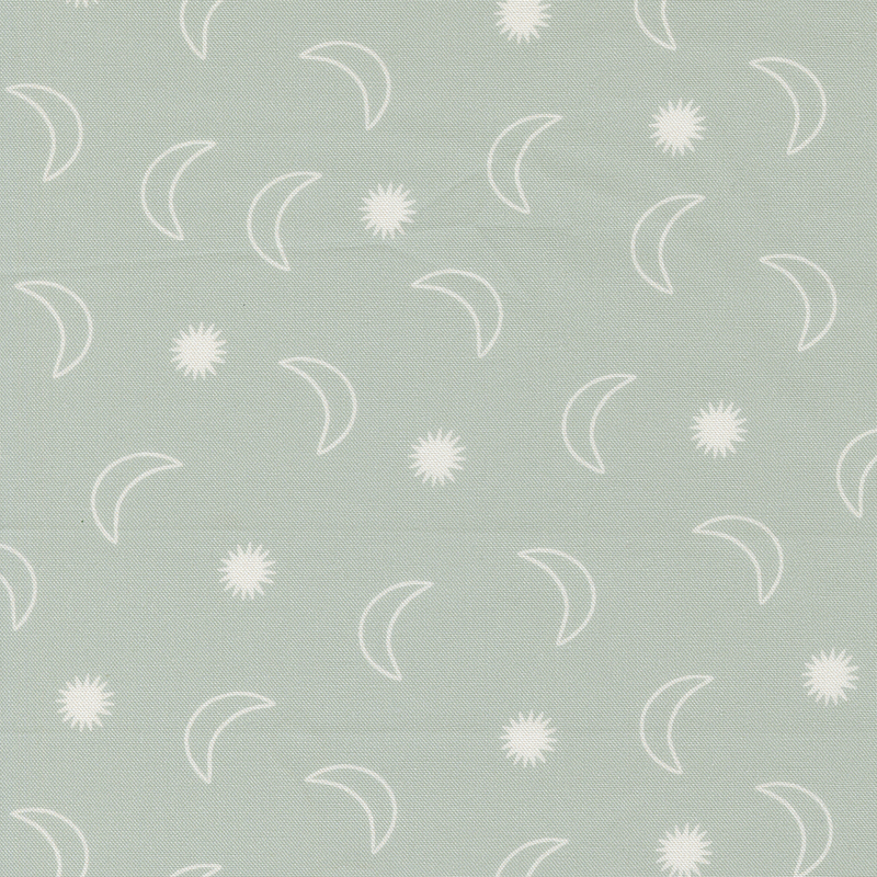 Green fabric with ditsy crescent moons and starbursts.