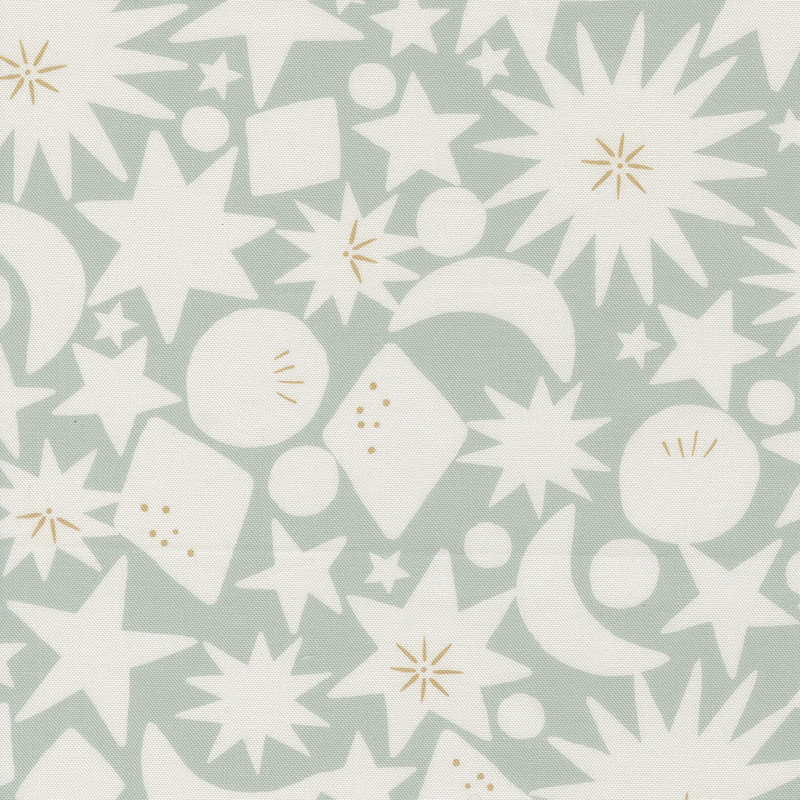 Green fabric with stars, starbursts, crescent moons, diamonds, and circles.