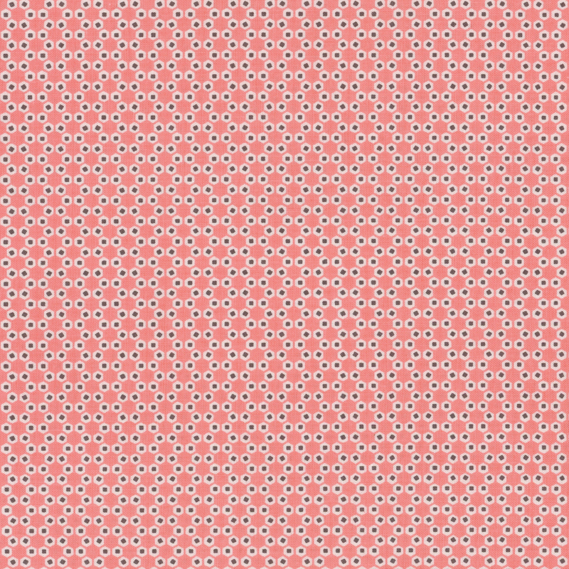 Coral pink fabric with geometric hexagon shapes.