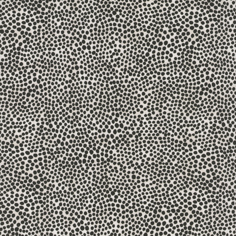 Light beige fabric scattered with a dense pattern of various sized black dots