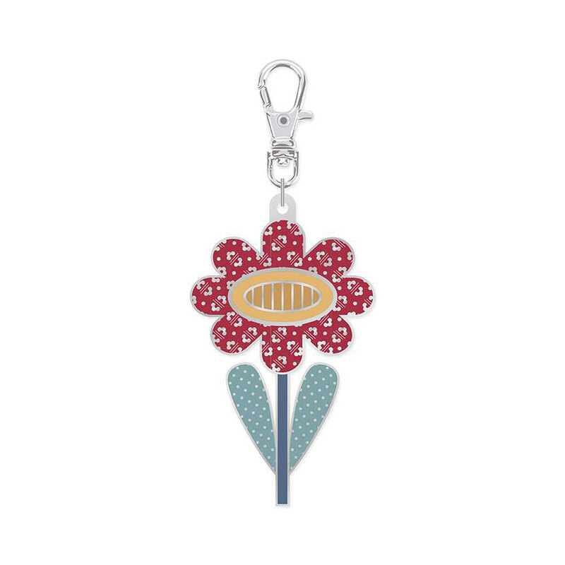 Enamel pin with a metal clip featuring the design of a red flower, isolated on a white background.