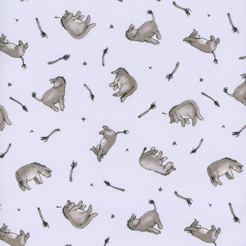 Pastel lilac fabric with tossed illustrations of Eeyore the donkey, thumbtacks, and his loose pinned tail.