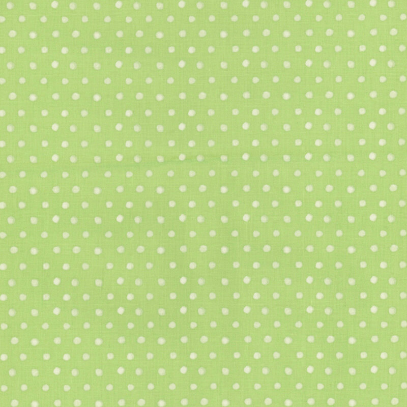 Light green background with scattered white polka dots.