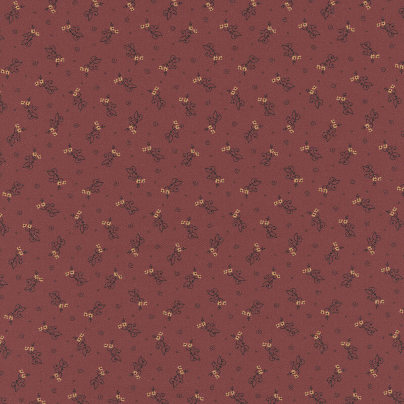 Deep red fabric with abstract ditsy floral shapes and swirls.