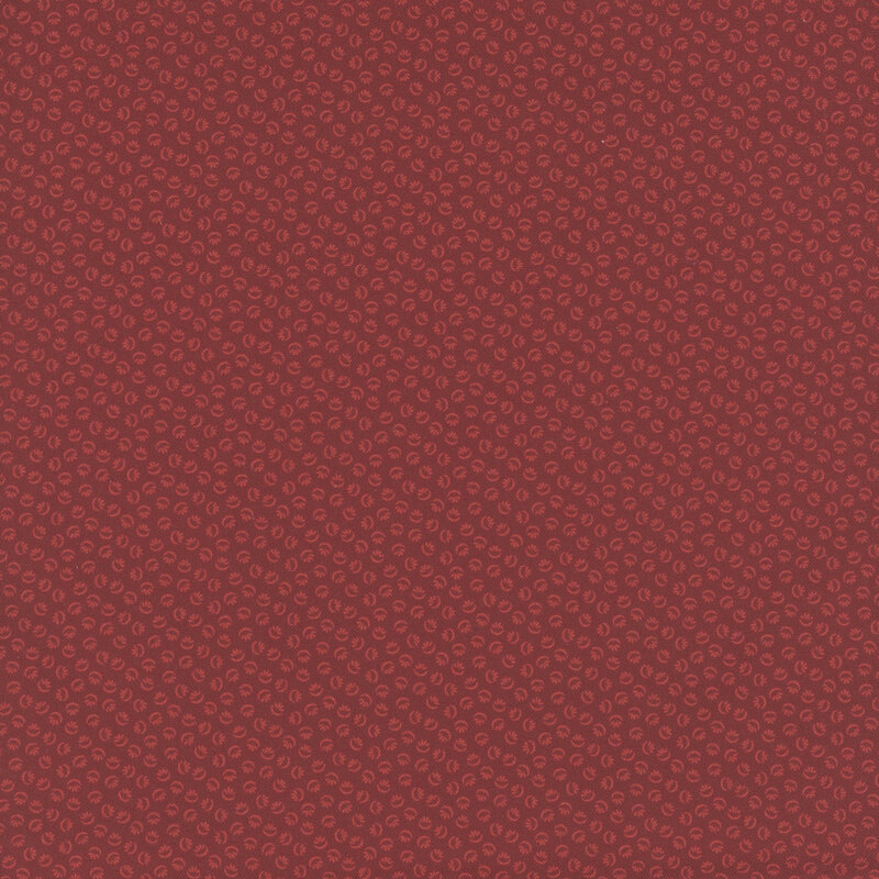 Red fabric with a tonal design of abstract ditsy shapes.