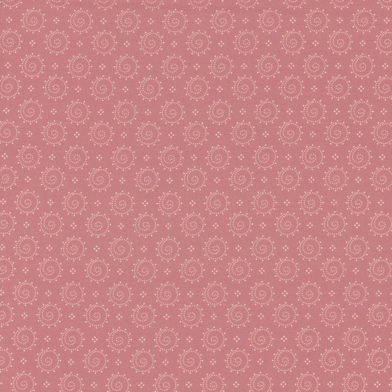 Pink fabric with a design of dotted circles with swirling centers.