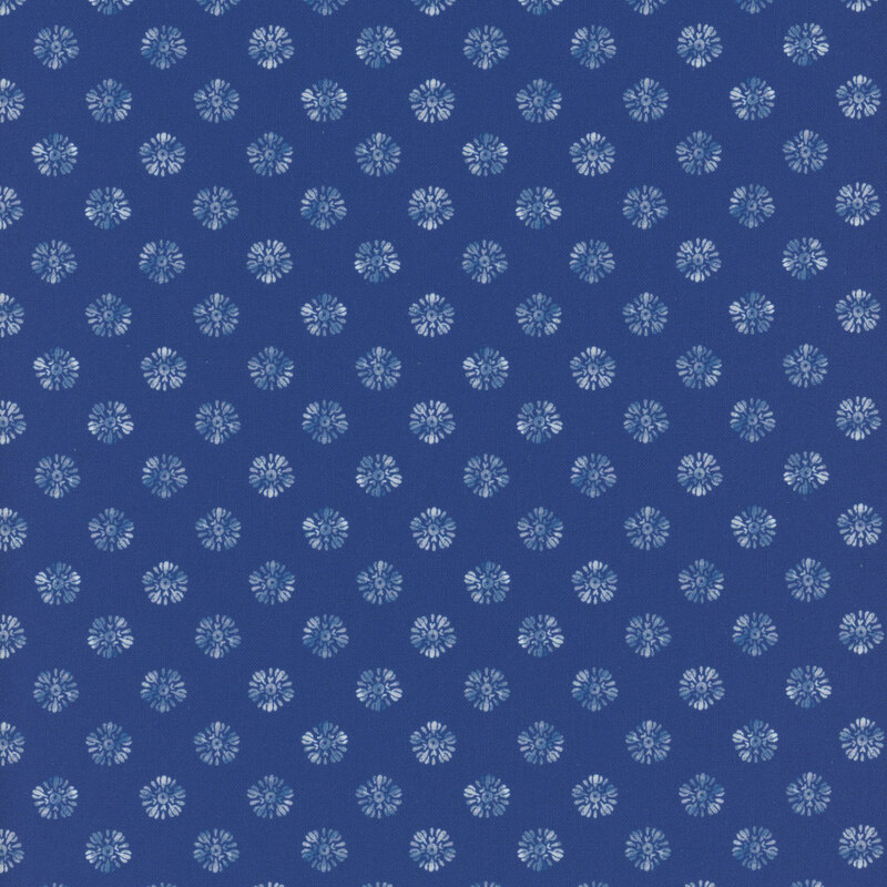 Dark blue fabric with a repeated pattern of small white floral shapes.