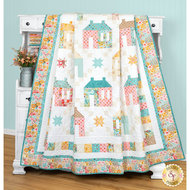 A head on shot of the quilt, artfully draped over a white armoire to demonstrate flow and form.