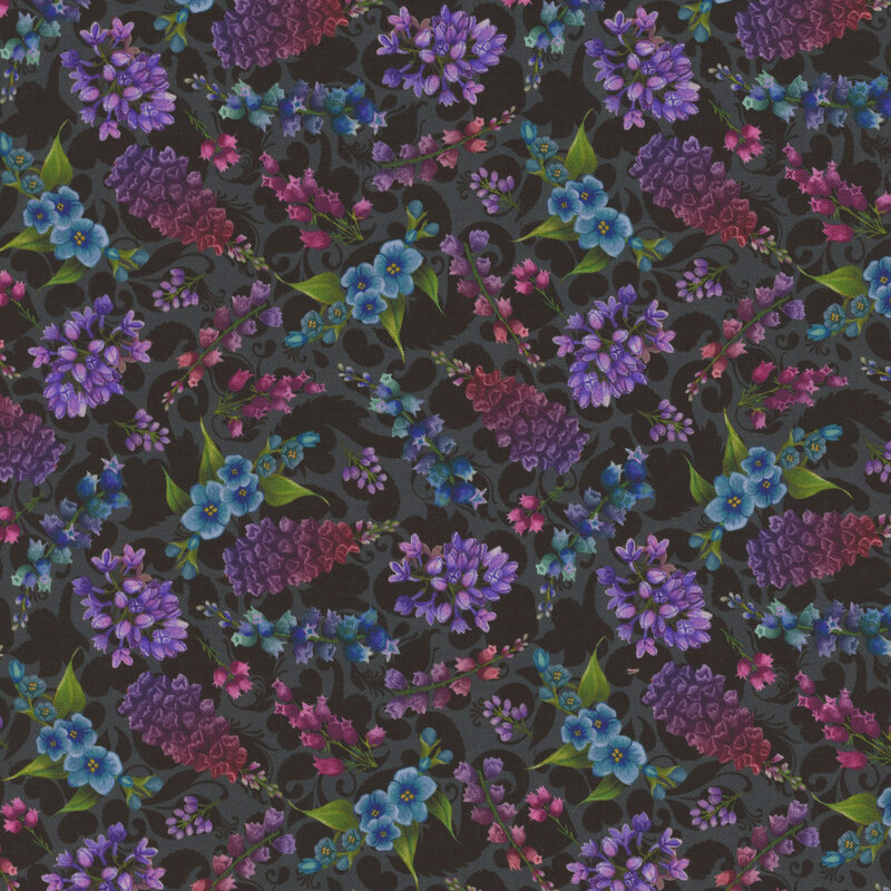Black fabric featuring various florals in purple, pink, and blue.
