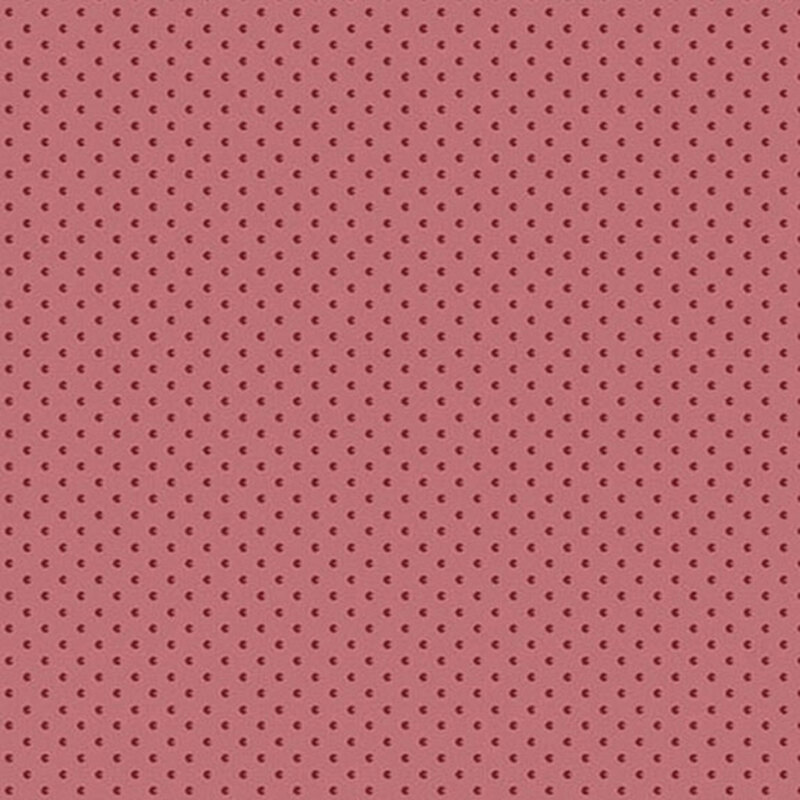 Berry pink fabric with tiny, tonal textured shapes.