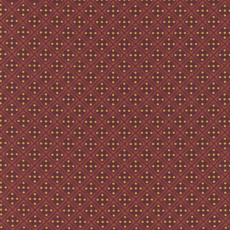 Maroon red fabric with a lattice design and small yellow dots in each square.