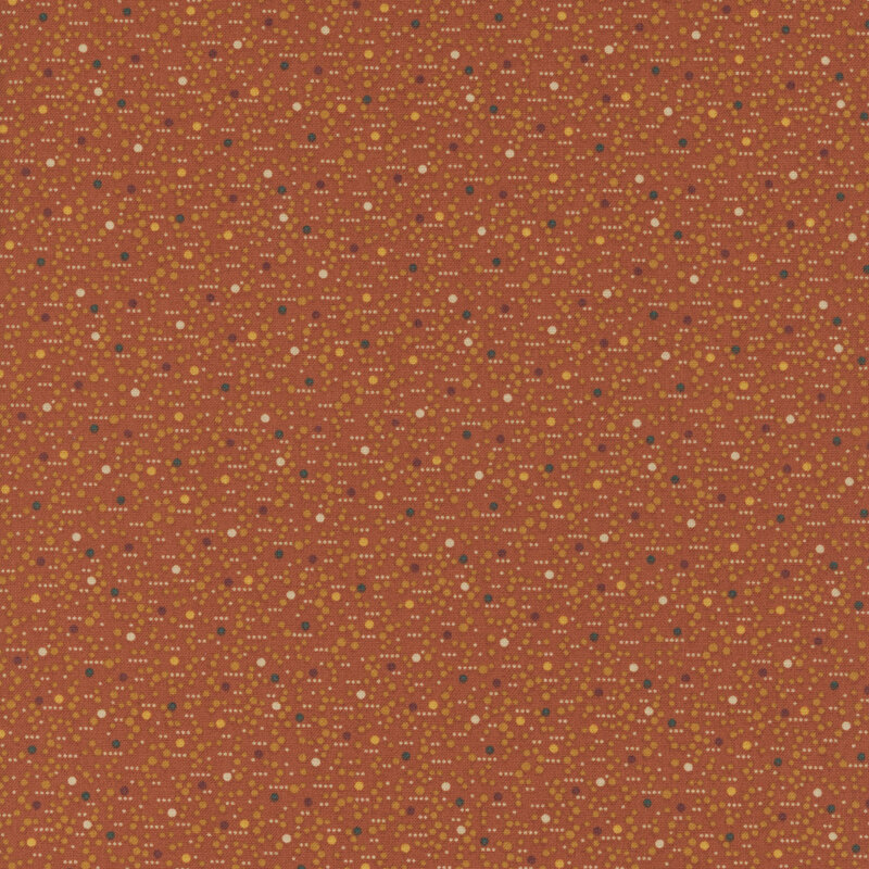 Burnt orange fabric with textured lines and multicolored dots.