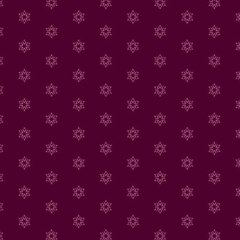 A dark magenta fabric with tonal pink starbursts.