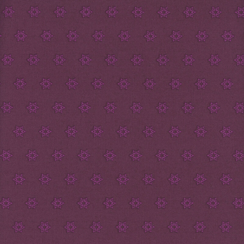 A dark magenta fabric with tonal pink starbursts.