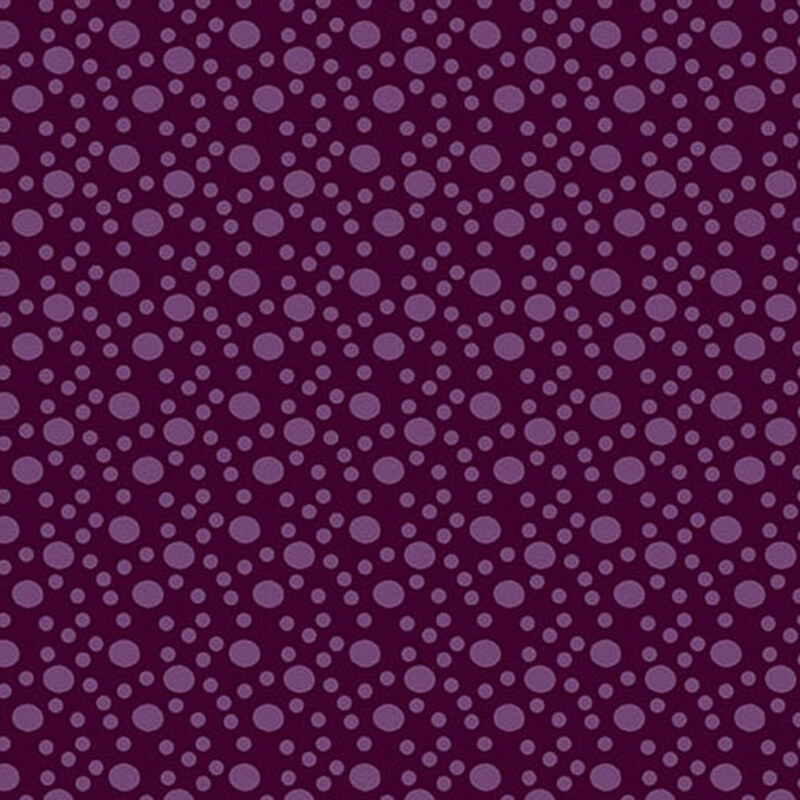 An plum purple fabric with large and small tonal dots.