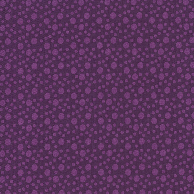 An plum purple fabric with large and small tonal dots.
