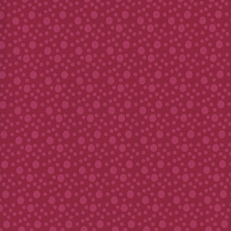 A bright candy red fabric with large and small tonal dots.
