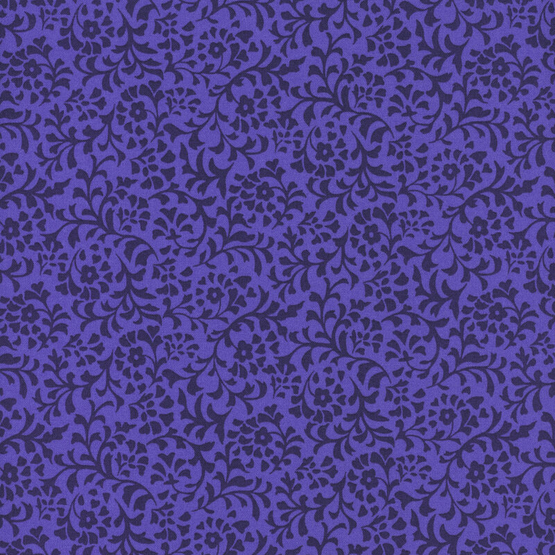 An iris blue fabric with a dense pattern of dark blue flower and leaf silhouettes.