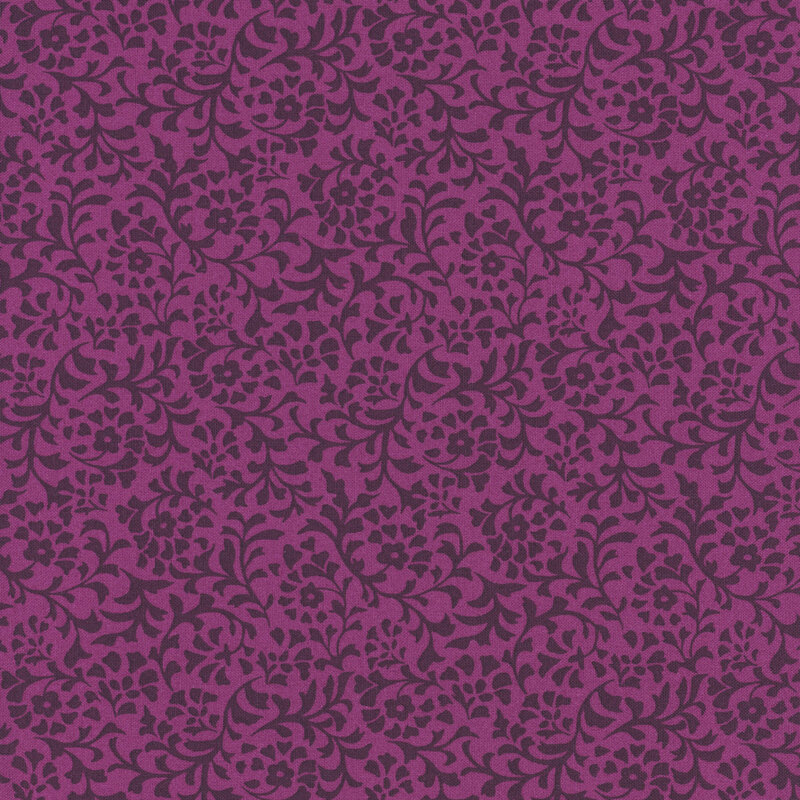A magenta fabric with a dense pattern of tonal flower and leaf silhouettes.