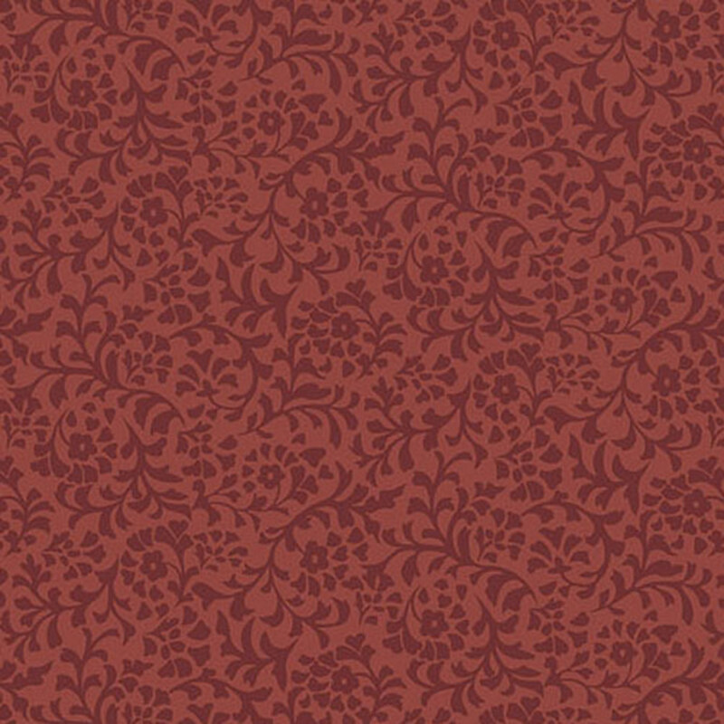 A brick red fabric with a dense pattern of tonal flower and leaf silhouettes.