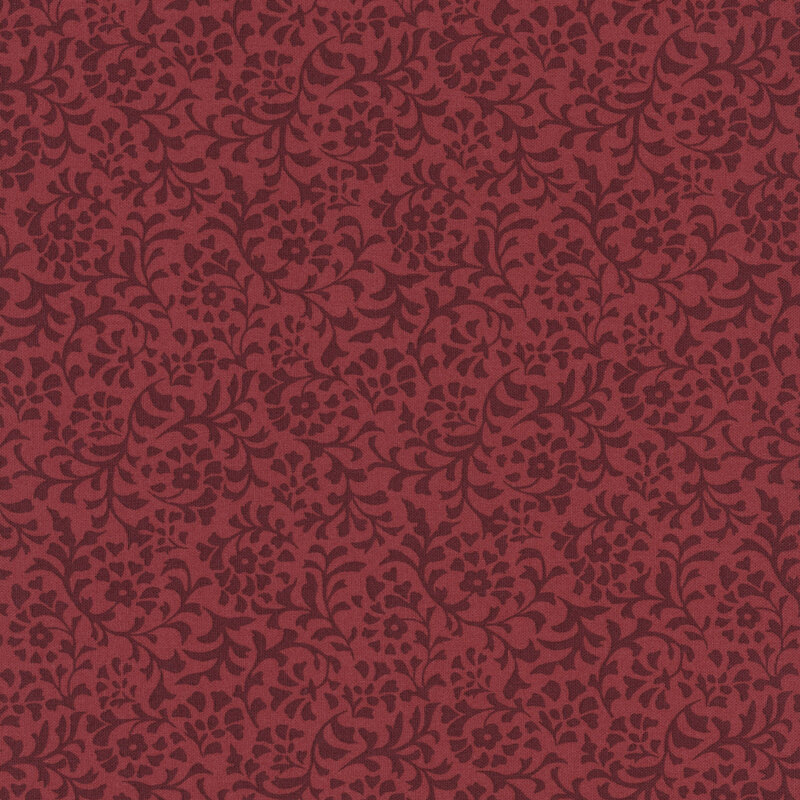 A brick red fabric with a dense pattern of tonal flower and leaf silhouettes.