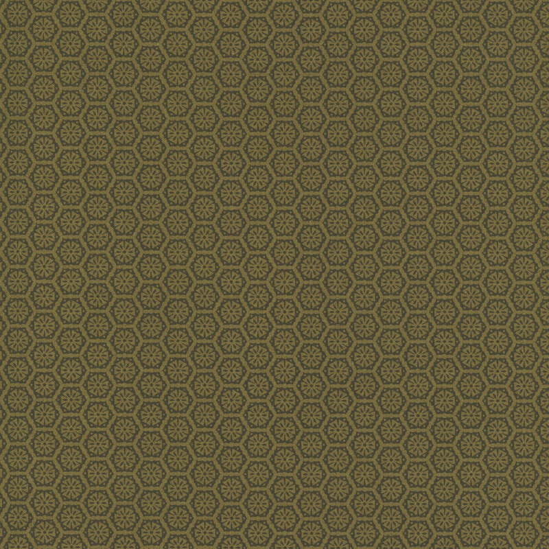 A brassy gold fabric with a tonal pattern of tiled geometric emblems.