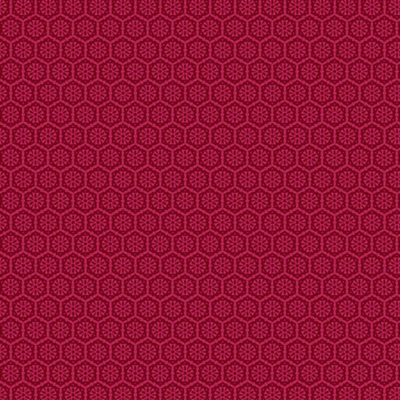 A bright pink fabric with a tonal pattern of tiled geometric emblems.