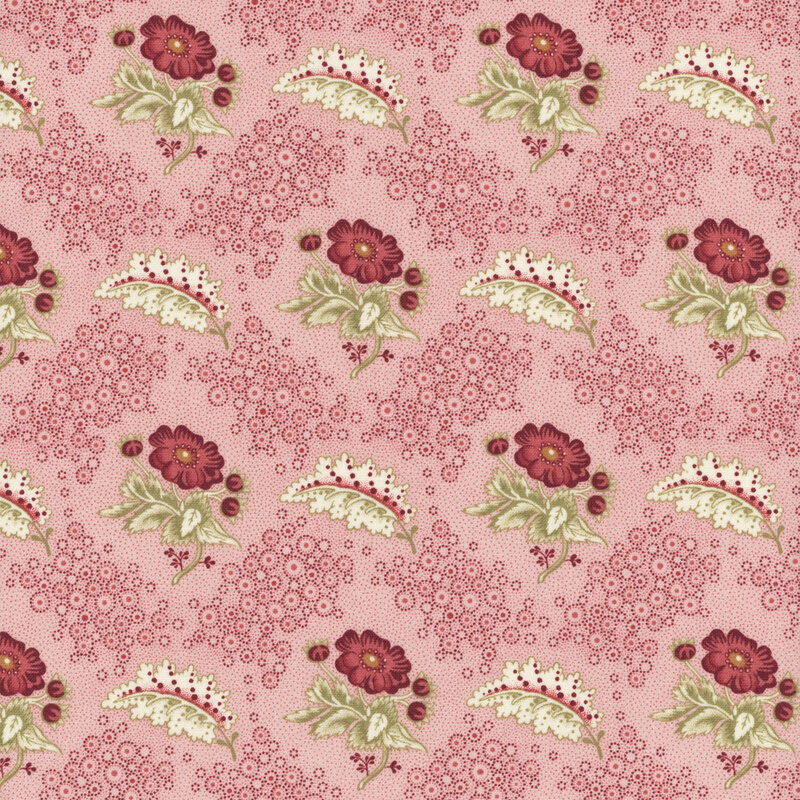 Textile pattern featuring red flowers and green leaves on a pink background, with decorative dots.