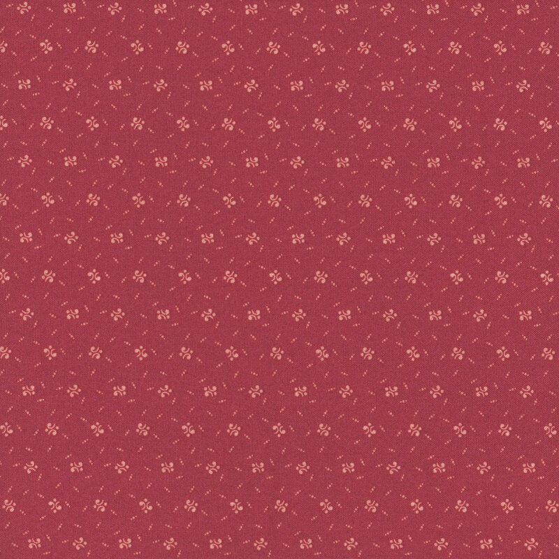 A seamless pattern of calico shapes on a red background.