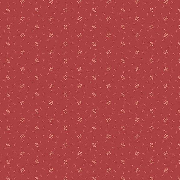 A seamless pattern of calico shapes on a red background.