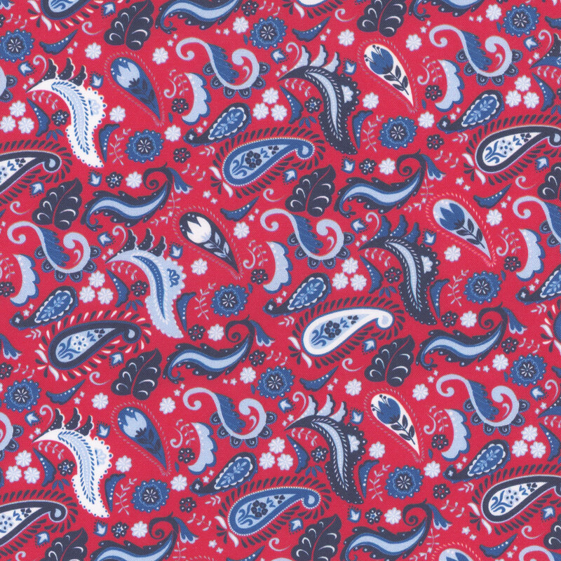 Repeating fabric pattern of paisley shapes in red, navy, and white shades, featuring floral accents.