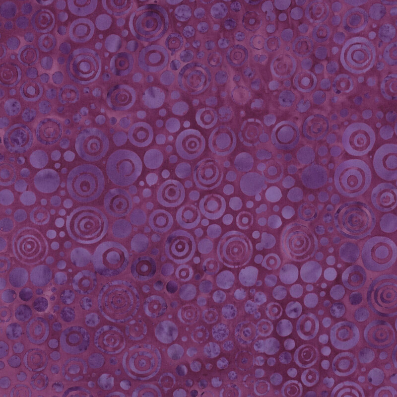 A textured purple background filled with various circular patterns and overlapping designs.