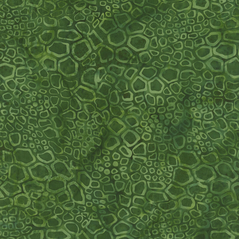 Abstract green fabric featuring various hexagonal and circular patterns resembling a reptile skin.