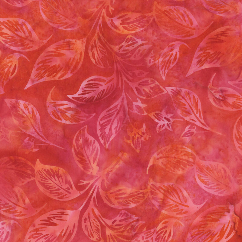 Patterned fabric with orange and red background featuring light-colored leaves and floral designs.