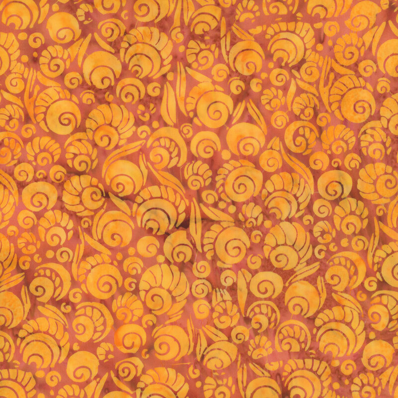 Mottled orange batik fabric with tonal swirls with designs to make them look like shells.